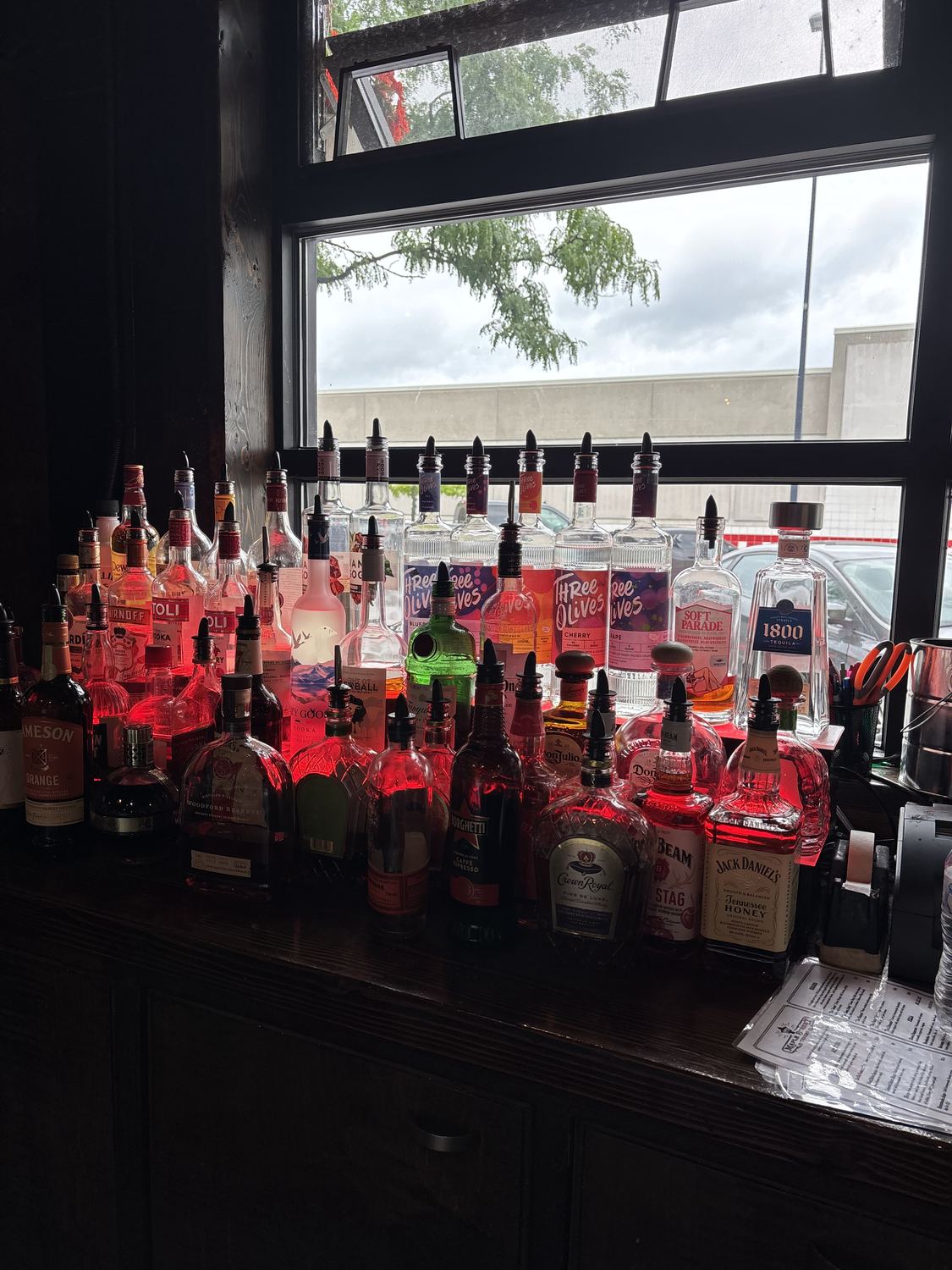 The back bar lined with bottles under the front window