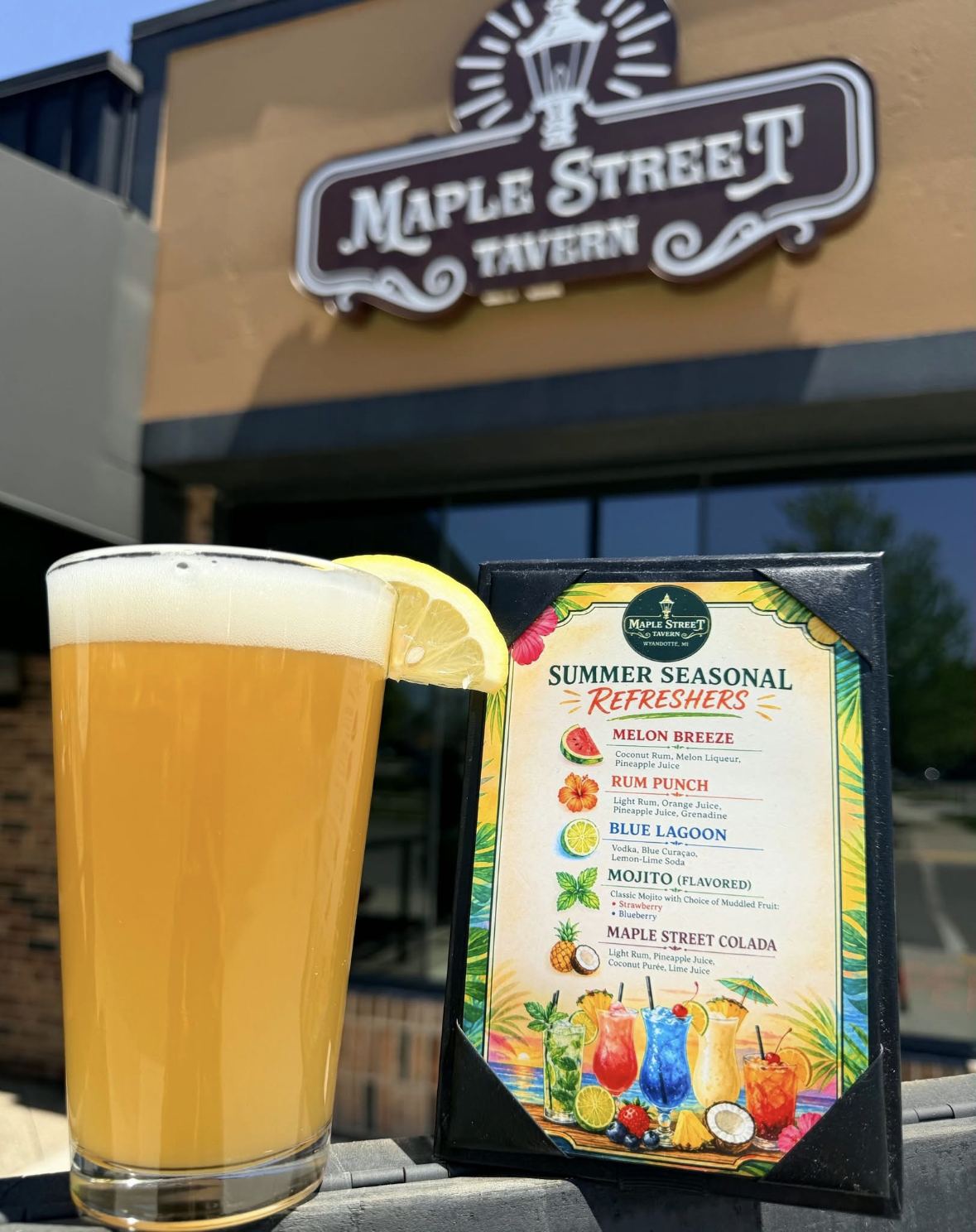 The Maple Street Tavern sign outside 166 Maple St with a cold beer on the rail